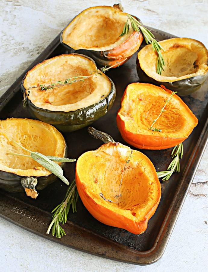 Recipe for buttery fresh herb bread stuffing with roasted acorn squash, served in individual squash bowls.