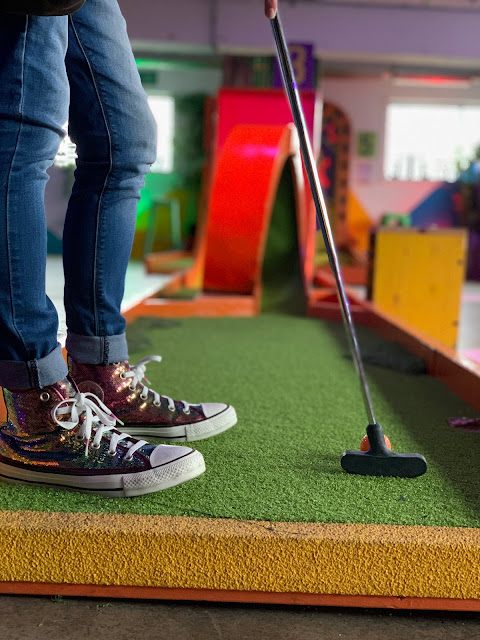 rainbow sequin converse on woman playing crazy golf at Plonk, Peckham Levels
