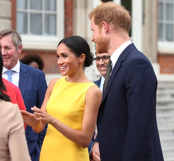 Meghan Markle wore Brandon Maxwell Yellow Crepe Midi Dress, Manolo Blahnik suede pump, Adina Reyter Diamond Amigos Curve Post Earrings