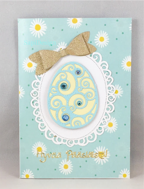 Keväinen pääsiäiskortti SapiDesign 2020 light blue Easter egg decoration gold bowtie cutting die Marianne Design SapiDesign