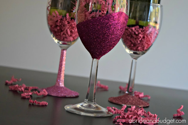 Three glitter wine glasses on a table.