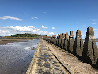 Causeway out to Cramond Island, Edinburgh with large, concrete pylons stretching out along it.  Photo by Kevin Nosferatu for the Skulferatu Project.