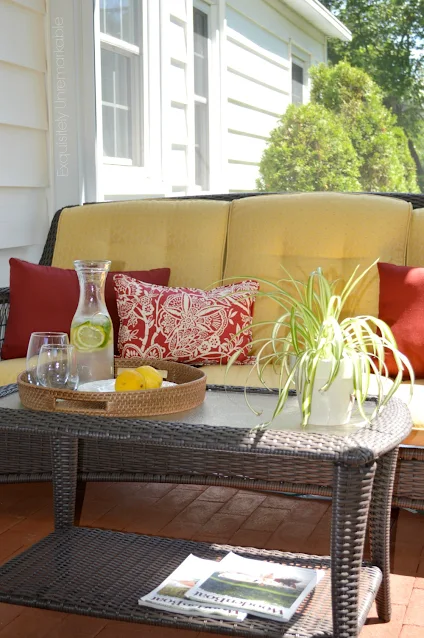 Screened in porch sitting area with sofa and coffee table