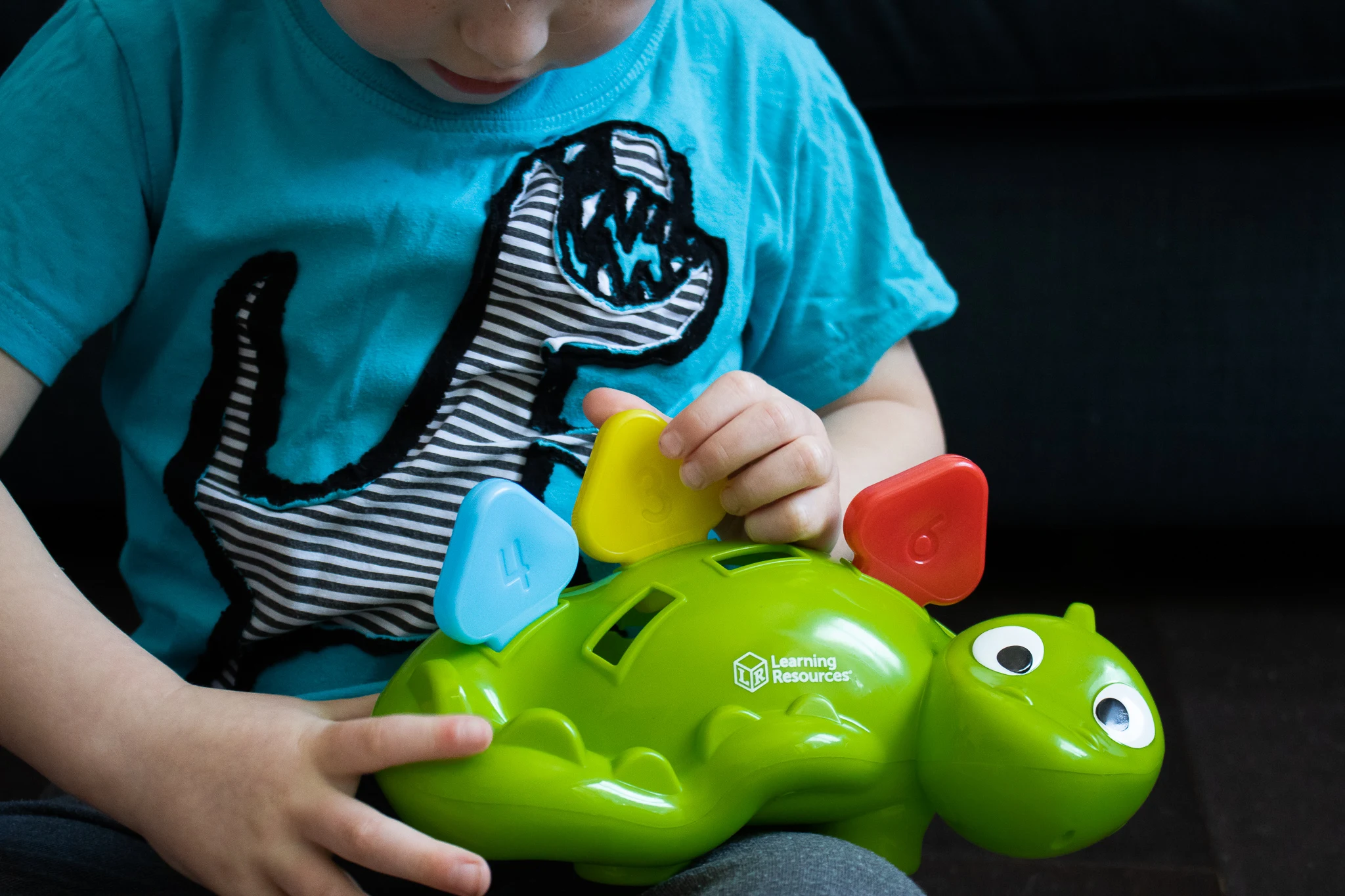 A preschooler learning numbers and colours with a review of Learning Resources Steggy The Fine Motor Dino