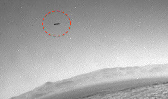 Flying Saucer in the sky over Martian surface.