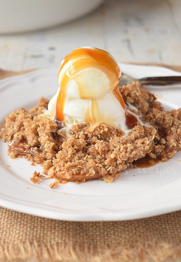 a white plate with old fashioned apple crisp topped with vanilla ice cream and caramel_1