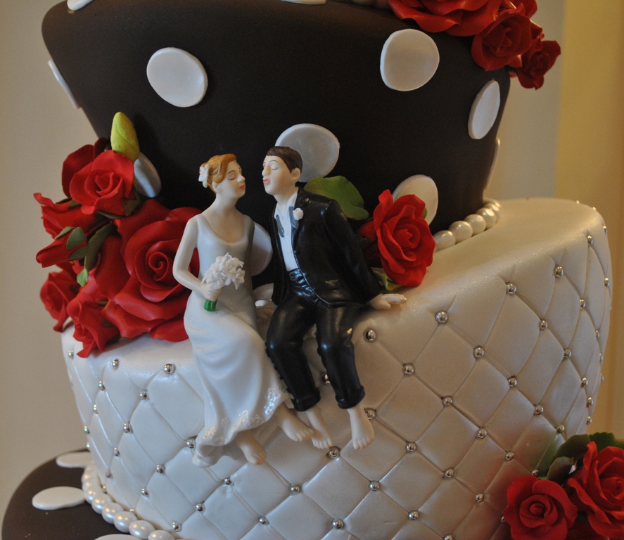 This 5tier black and white topsy turvy wedding cake is highlighted with red
