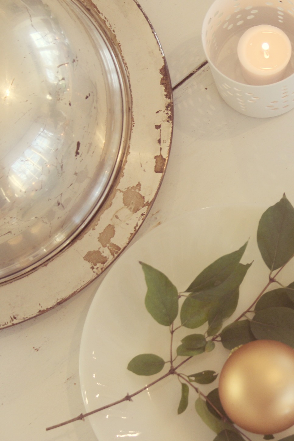 Vintage silver on white farmhouse table with gold and greenery