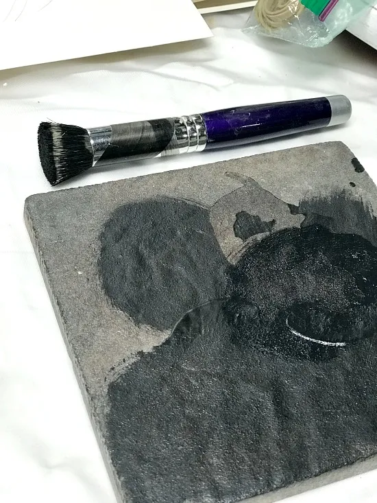 black paint on a tile stencil pallet