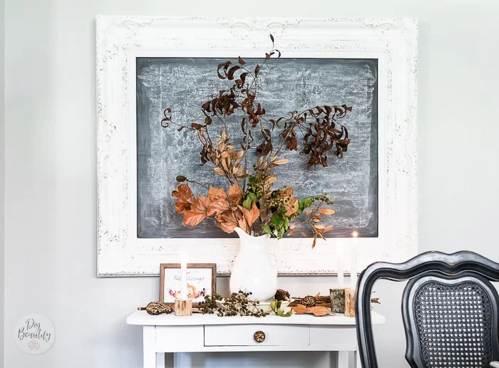 large chalkboard, side table with ironstone pitcher filled with fall leaves, berry stems, branches and seed pods