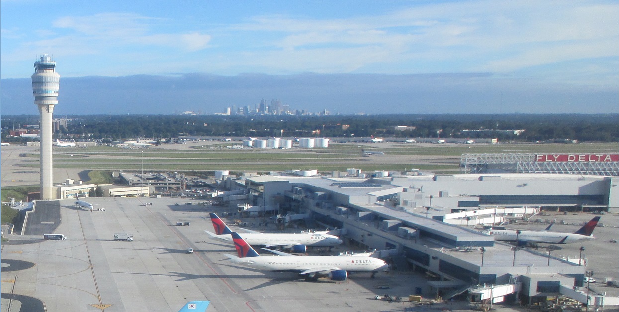 Atlanta airport control tower with city skyline behind. 