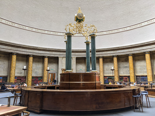 inside large dome with wooden circular bench and clock