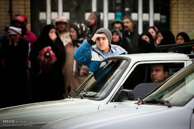 A mesmerized teenage boy watches a public execution in Iran. A mesmerized teenage boy watches a public execution in Iran.