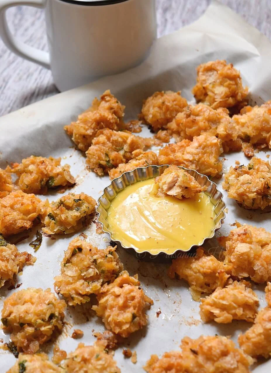 Oven Baked Popcorn Chicken placed on a tray with sauce