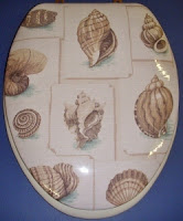 Decorative, hand-upholstered padded toilet seat with sea shells pattern lid.