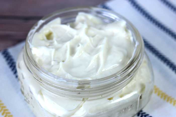 How to make a whipped body butter for eczema or dry skin. This home remedies for eczema helps relieve dry skin and moisturize with shea butter, cocoa butter, and aloe vera butter and essential oils. It also has herb infused oils. This is like a lotion or cream but with more oil and no water.  Use during a flare up for natural relief. Use on hands, legs, or arms for relief. Homemade DIY treatment for eczema with an easy to make recipe. #eczema #bodybutter