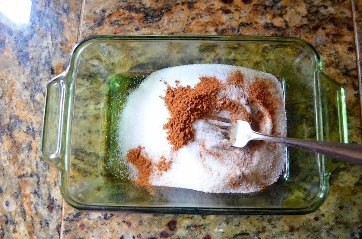Cinnamon and Sugar in a glass container to dip Cinnamon Sugar Muffins in.