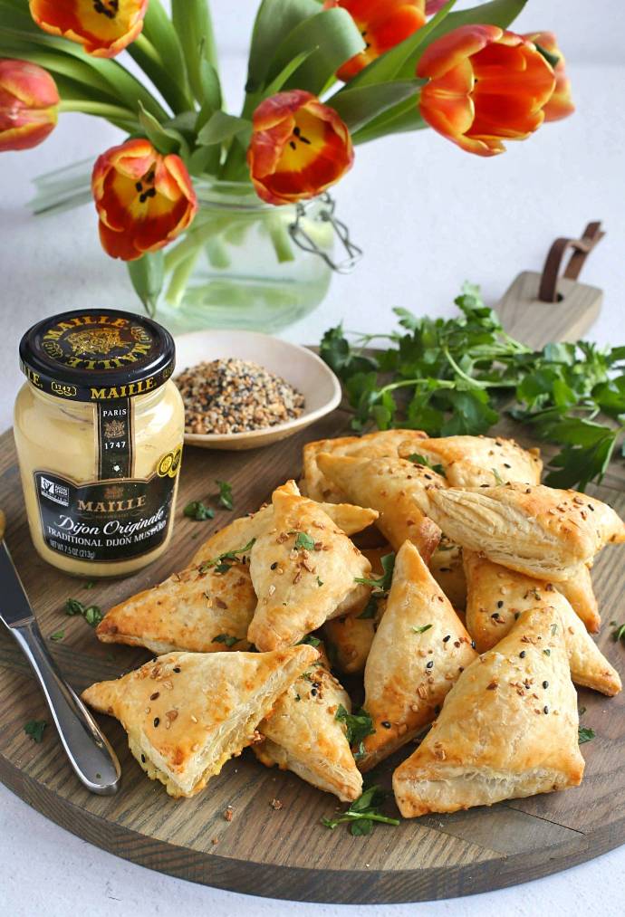 Recipe for mini savory turnovers, filled with potato, caramelized onion and mustard and wrapped in puff pastry.