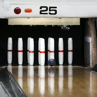The game is played on the same lanes as regular "tenpin" bowling, but fundamental differences separate the two variations. First of all, you get three balls per frame, rather than two. Second, the balls fit in the palm of your hand and only weigh up to two pounds, seven ounces. The pins are almost 16 inches tall and are shaped like cylinders. Third, and most interesting, pins knocked down that remain on the lane are in play as "wood". This often makes for easier - and sometimes more frustrating - shots.