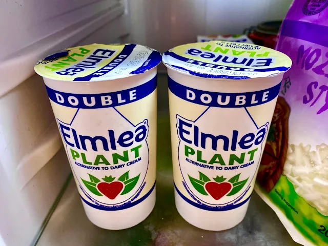 2 pots of Elmea Plant Double Cream alternative to dairy cream on a fridge shelf