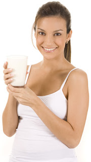 Young Woman Holding a Glass of Milk