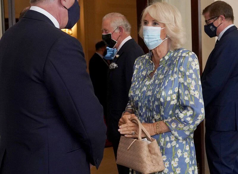 Camilla wore a floral silk blue dress from Fiona Clare, and she carried beige leather bag from Bottega Veneta