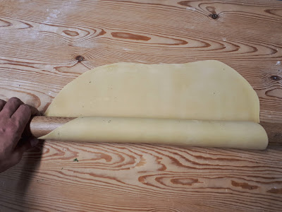 rolling pasta dough with a dough roller