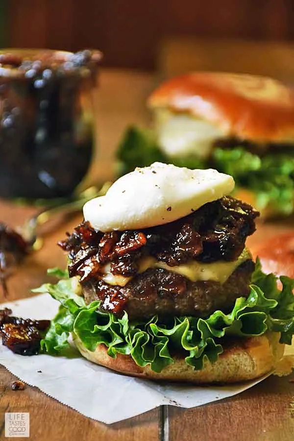 Bacon Jam Burger assembled with lettuce, melted Gruyere cheese, bacon jam, and a poached egg on top