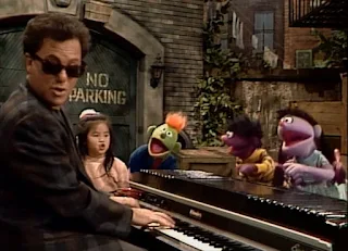 Billy Joel sings The ABC Alphabet Song with a lot of kids and some of the Anything Muppets.