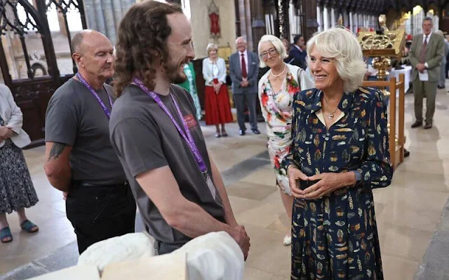 Charles wearing a crisp grey suit and Camilla wore her favourite dress by Fiona Clare