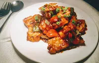 Garnished Chilli paneer serving