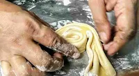 Folding and coiling dough sheet for making parotta dough ball