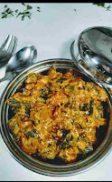 Serving bhindi masala in a bowl fork and spoon in background