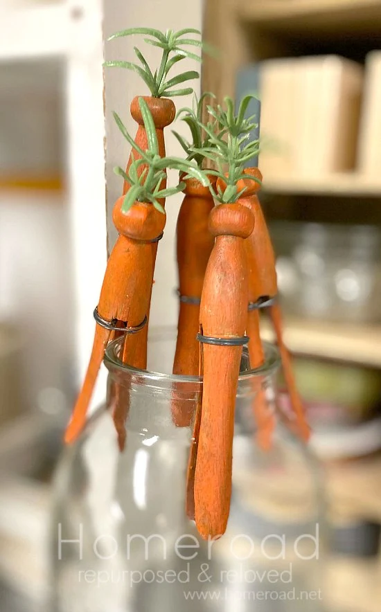 Clothespin carrots drying on a bottle