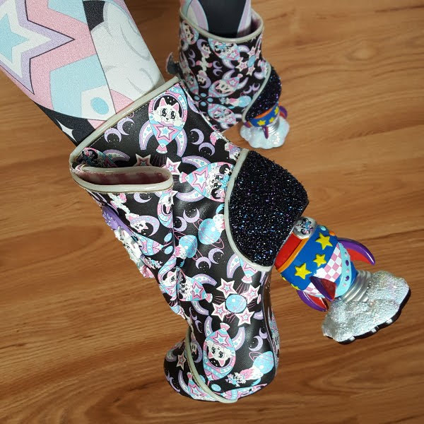 close up of rocket shaped heel on boot and cat and dog galaxy print uppers