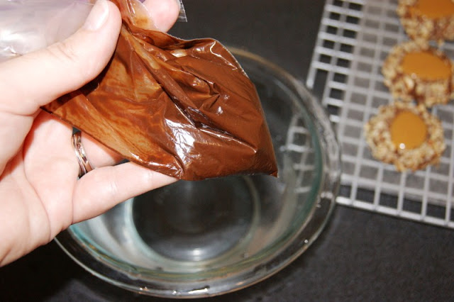 Insanely Delicious Turtle Cookies ... soft chocolate-pecan thumbprint cookies filled with caramel.  Yum! www.thekitchenismyplayground