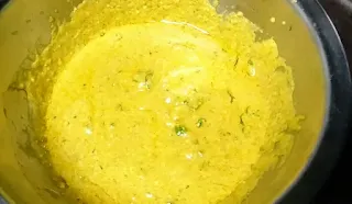 Yellow color banjara masala paste in a mixing bowl
