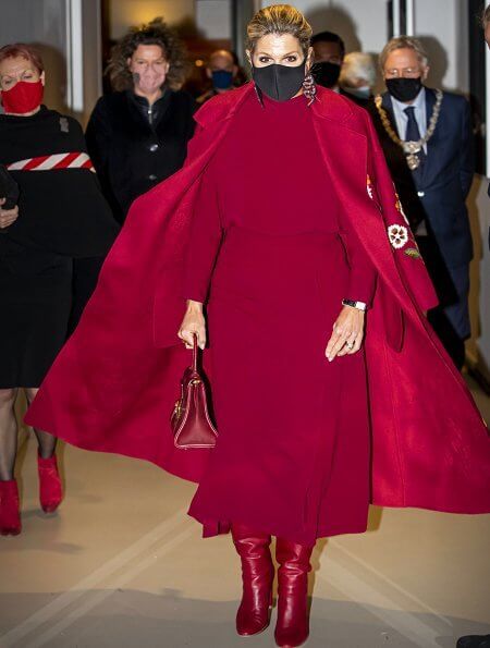Queen Maxima wore a claret multi embroidered wool cashmere coat from Oscar de la Renta, and a red open-back midi dress from Massimo Dutti