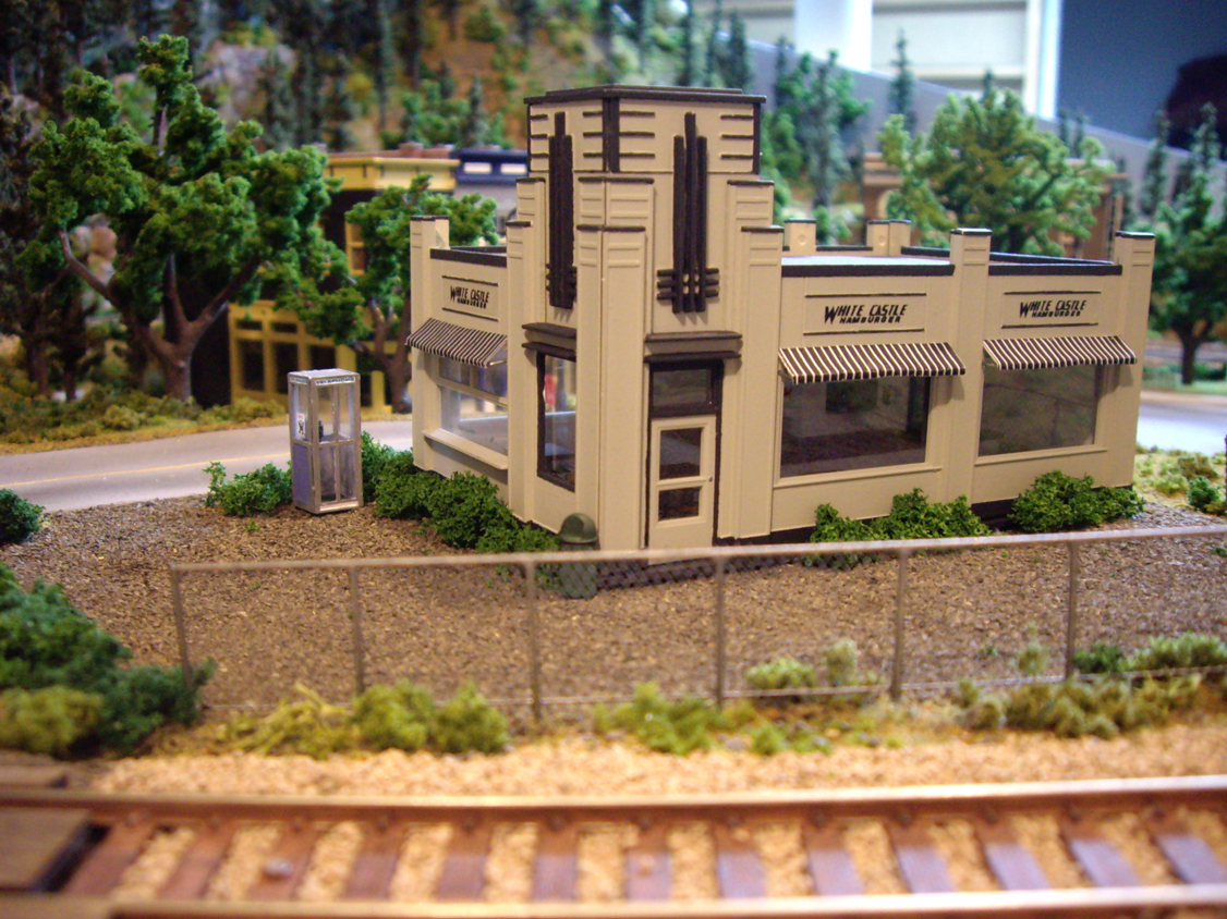 A sidewalk scene with details from a Walther’s City Accessories kit including fire hydrants, parking meters and a phone booth