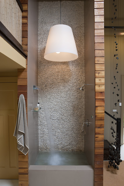 River rock and a two-story shower finish this sustainable home-spa by Washington, DC architect and interior design firm Studio Santalla