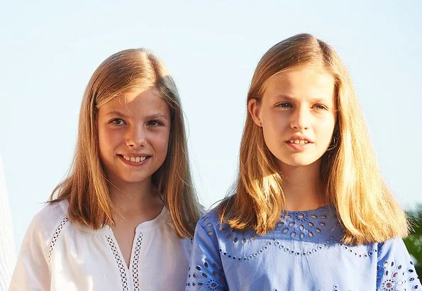 Queen Letizia wore a new white cotton dress from Dafalia collection of Hugo Boss. Princess Leonor and Infanta Sofia on holiday