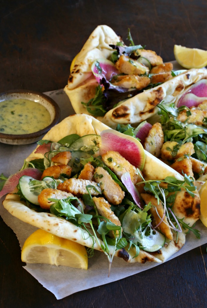 Recipe for crispy chicken pieces, mixed greens and a creamy lemon dressing served in naan bread or a tortilla.