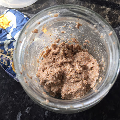 A jar containing a small amount of flour and water mixture