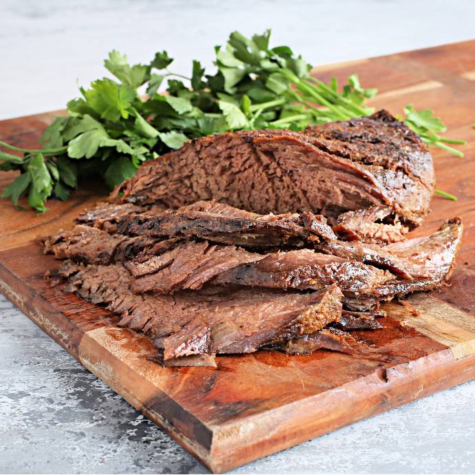 Recipe for a beef brisket, rubbed with mustard, liquid smoke and spices, wrapped and slow cooked in an oven and served over vegetable fritters.