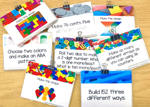 Photos of math task cards for different manipulatives held together with binder clips.