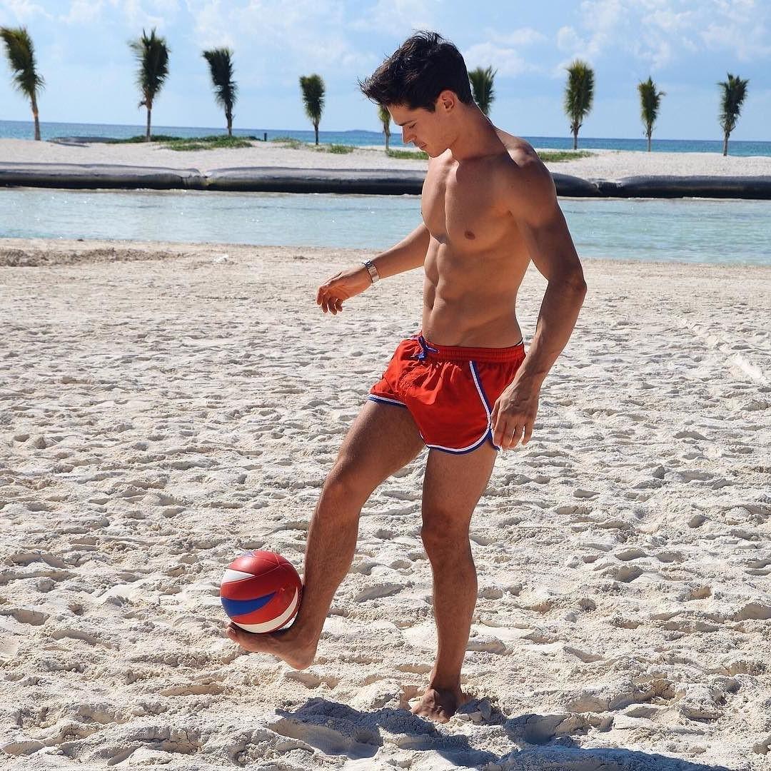 fit-shirtless-beach-boy-playing-ball