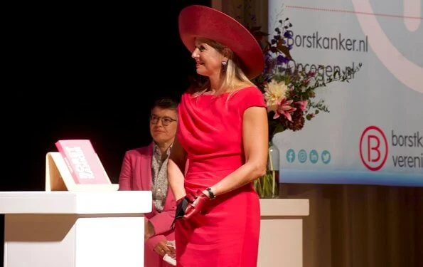 Dutch Breast Cancer Association. Queen Maxima wore a new short sleeve berry-red dress by Natan. Royal purple hat, earring Oscar de la Renta