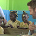 Gerard Butler shares a meal with school children in Haiti to highlight the work of Scottish charity which provides lunches for pupils just days after his Malibu home burnt down