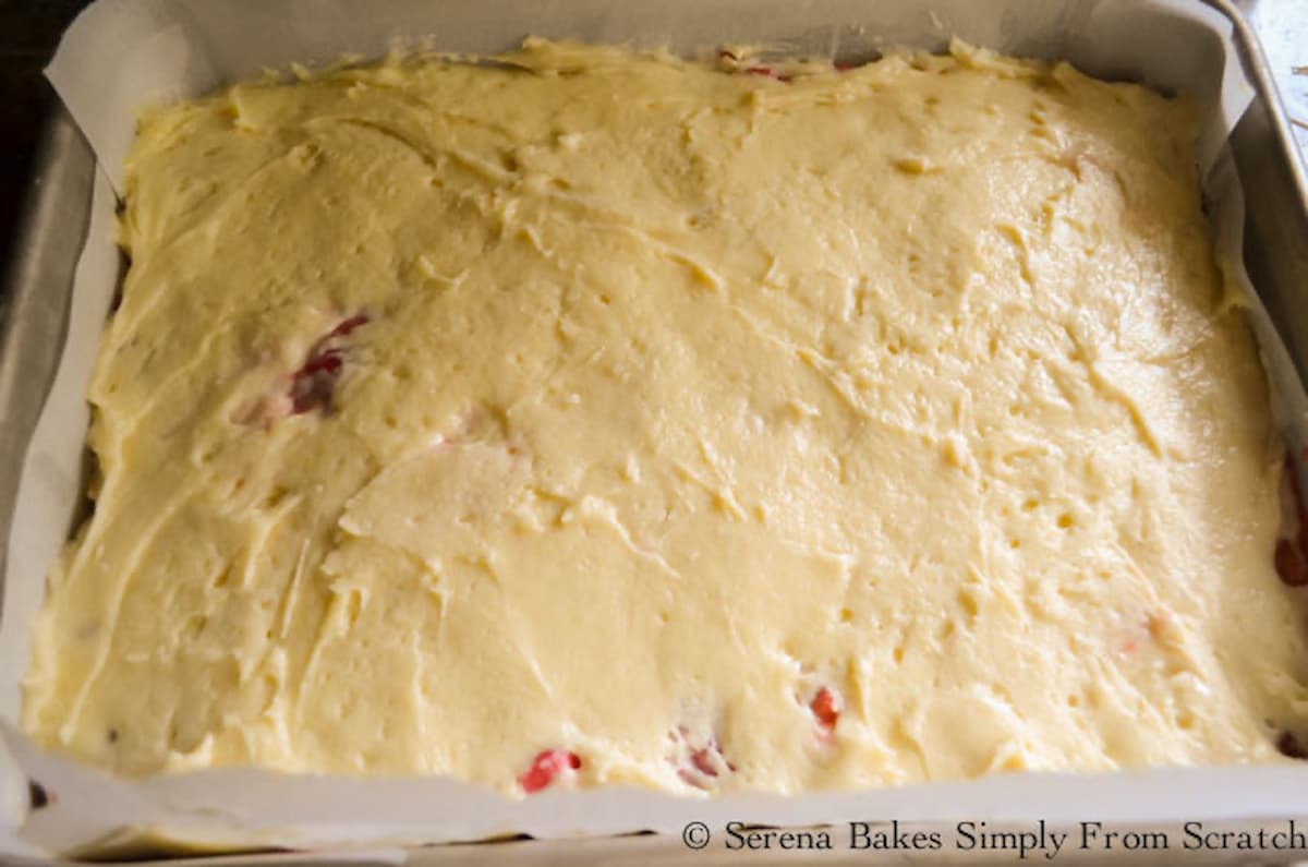 Strawberry Rhubarb Coffee Cake batter spread over the top of Strawberry Rhubarb Filling.