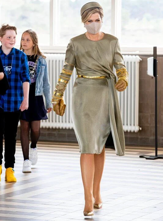 Queen Maxima wore an embellised draped midi dress by Claes Iversen. Gianvito Rossi gold plexi pumps. Begum Khan clutch bag